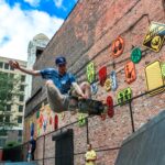 man skateboarding near brown concrete building during daytime