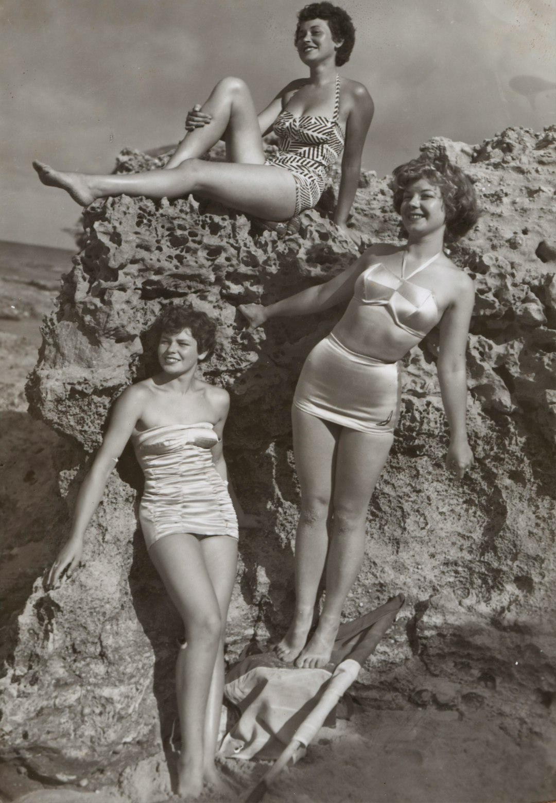 Bernice Kopple, Photograph used in article 'Bonny Scot Beach Girl', Australia,1950s by Skateboard Brands grayscale photo of three women standing and sitting on rocks