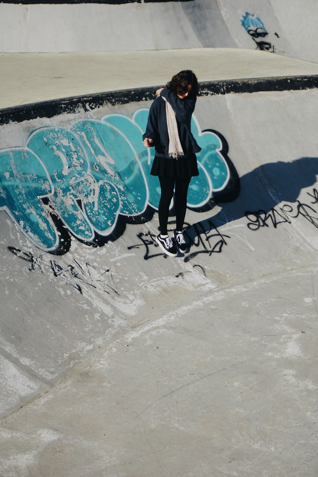 A person standing on a skateboard in a skate park