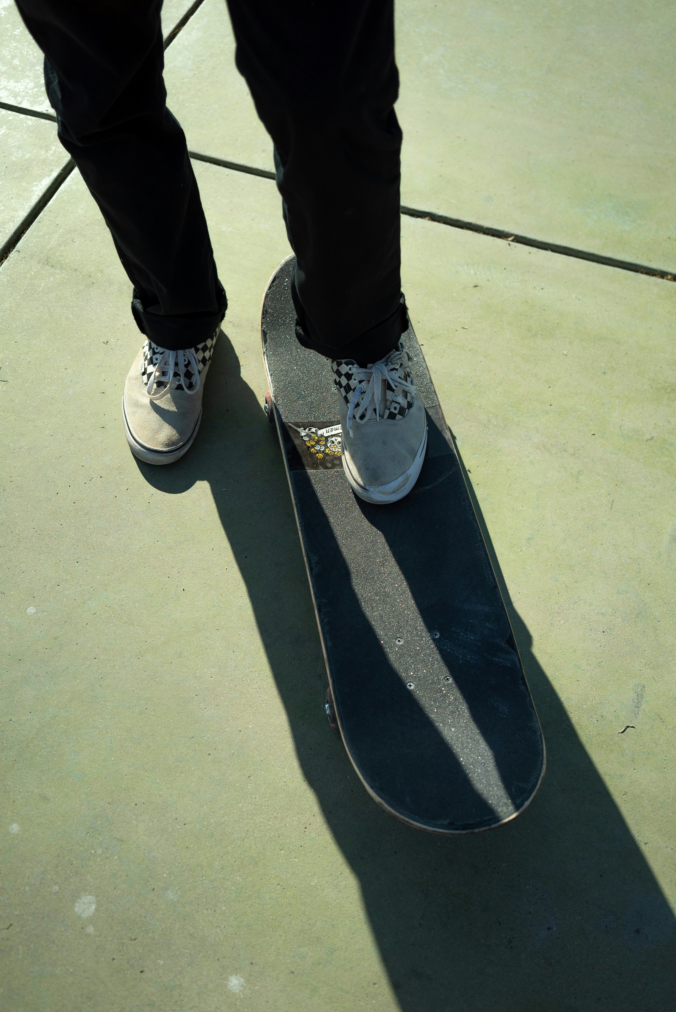 ❓ Your Burning Questions Answered: Skateboard FAQs by Skateboard Brands person in black pants and white and blue sneakers
