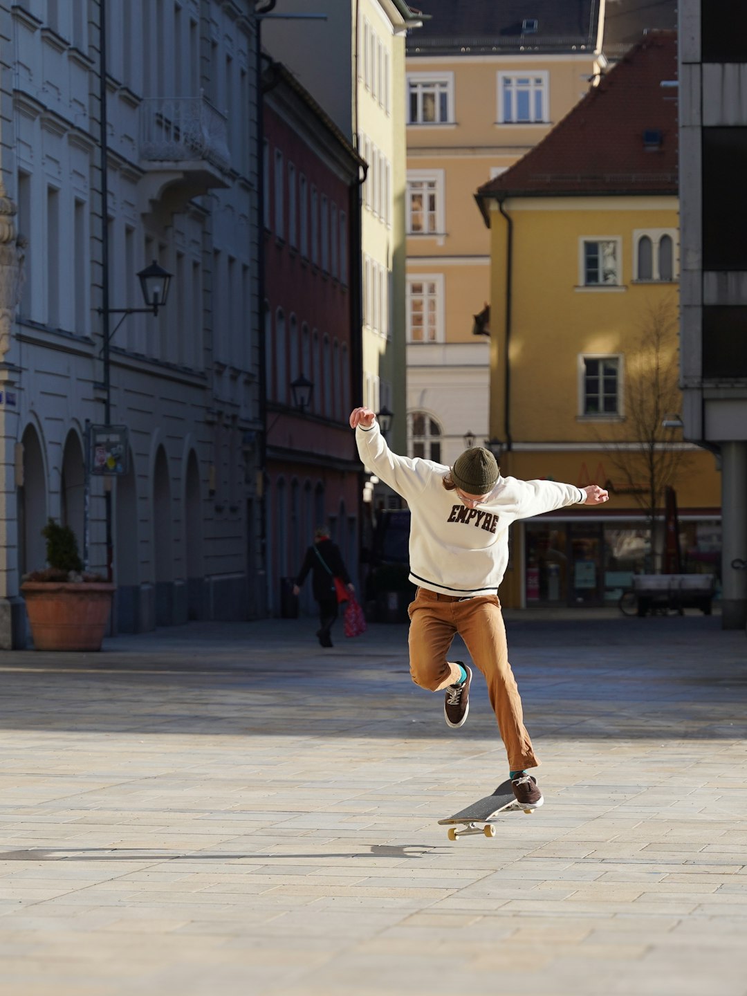 European skateboard brands by Skateboard Brands a man riding a skateboard down a street next to tall buildings